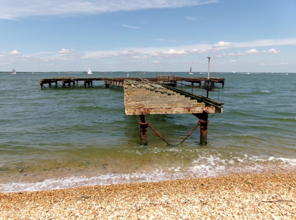 Derelict pier at Fort Victoria on the Solent, seen from the shingle beach.