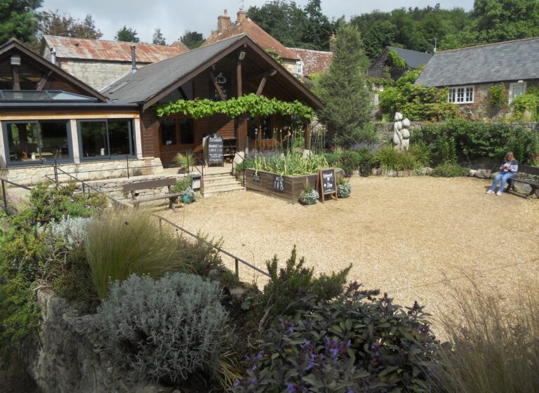 Entrance to The Garlic Farm restaurant near Newchurch, surrounded by garden planting.