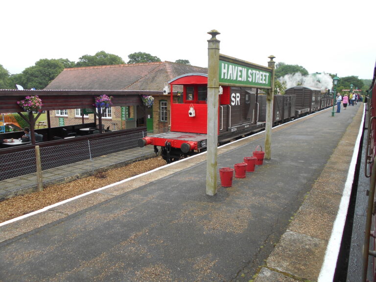 Havenstreet station sign beside heritage railway carriages at the Isle of Wight Steam Railway.